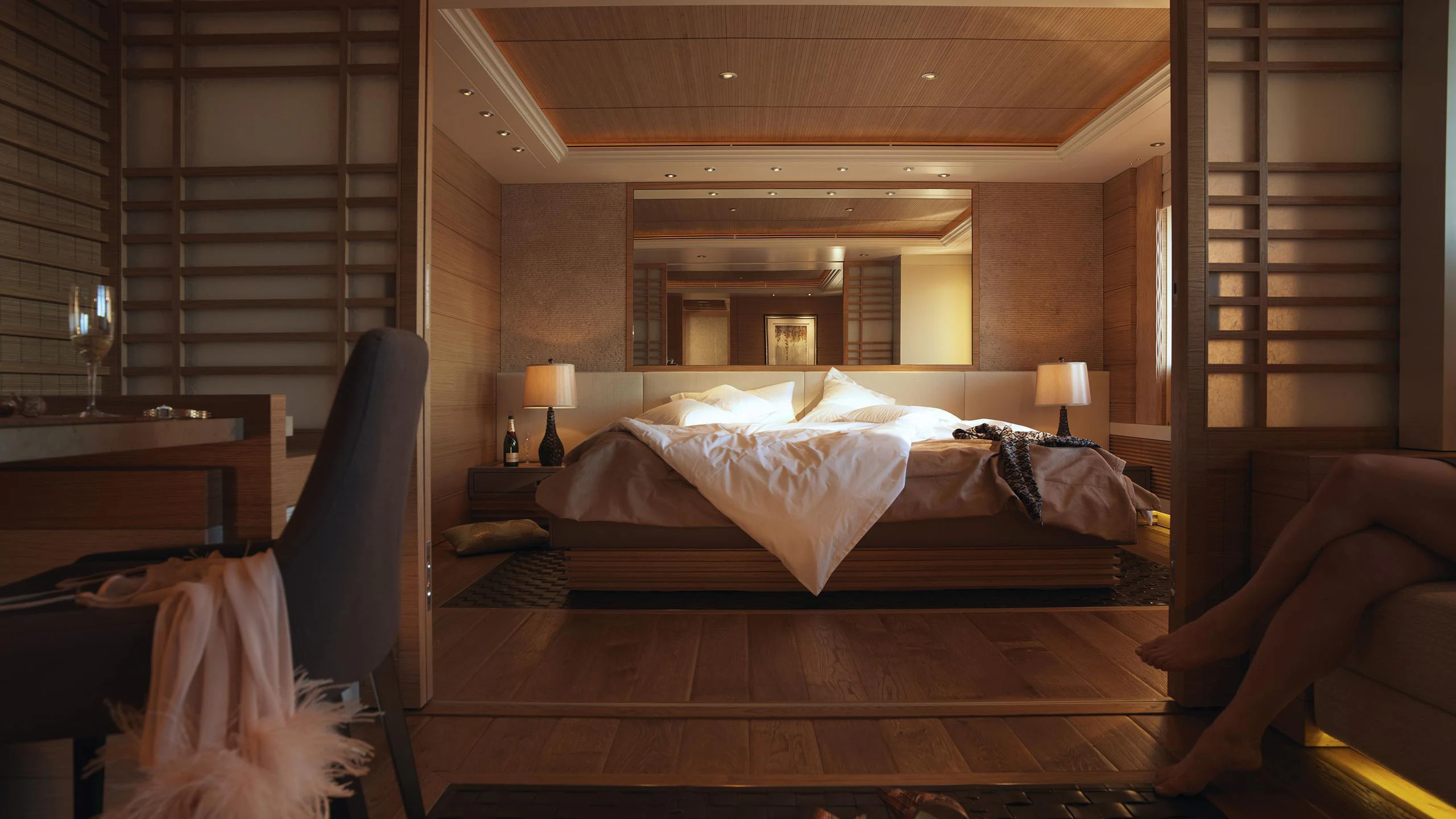 a room with a bed and a chair aboard NAIA Yacht for Charter