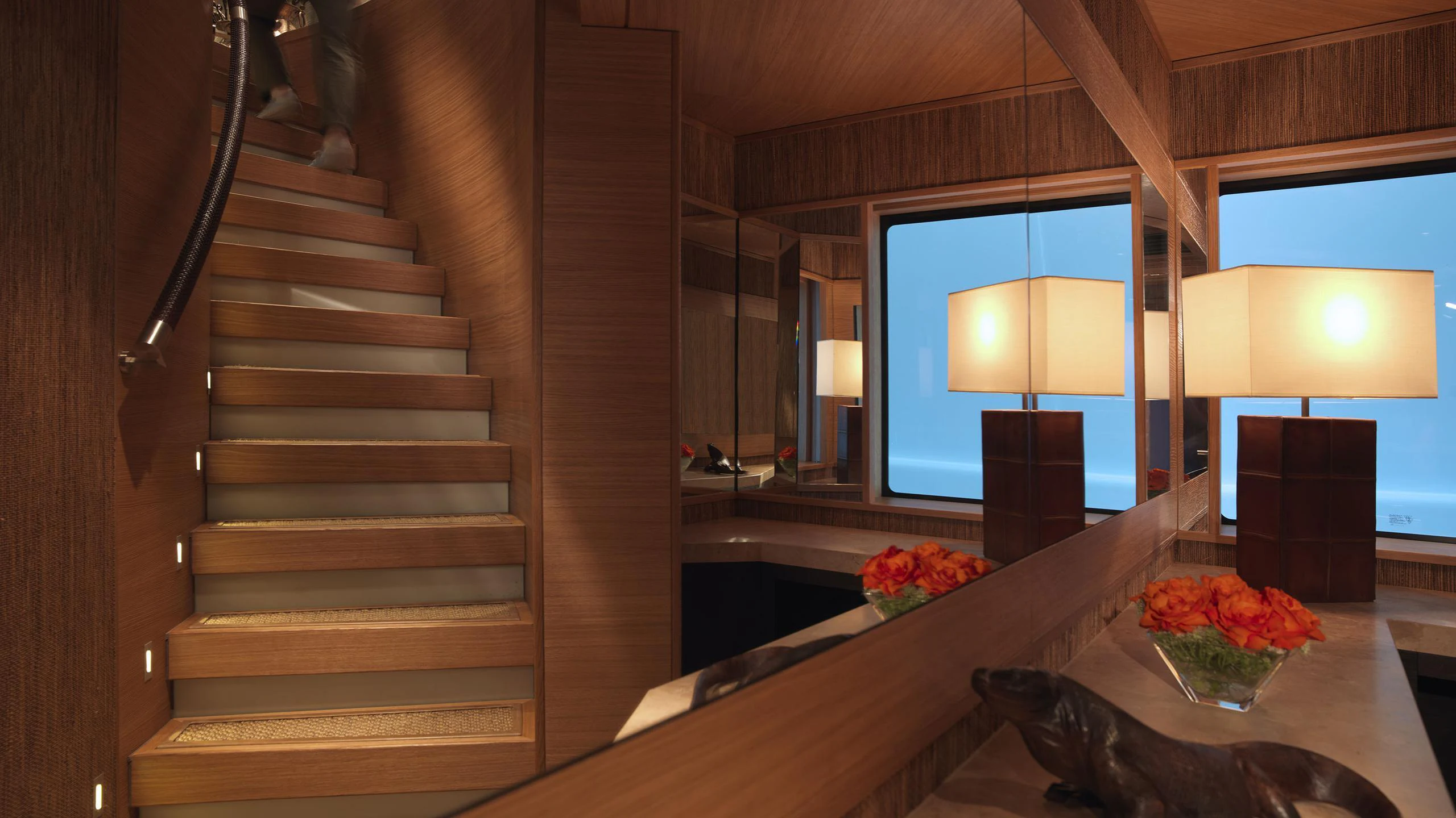 a wooden staircase in a house aboard NAIA Yacht for Charter