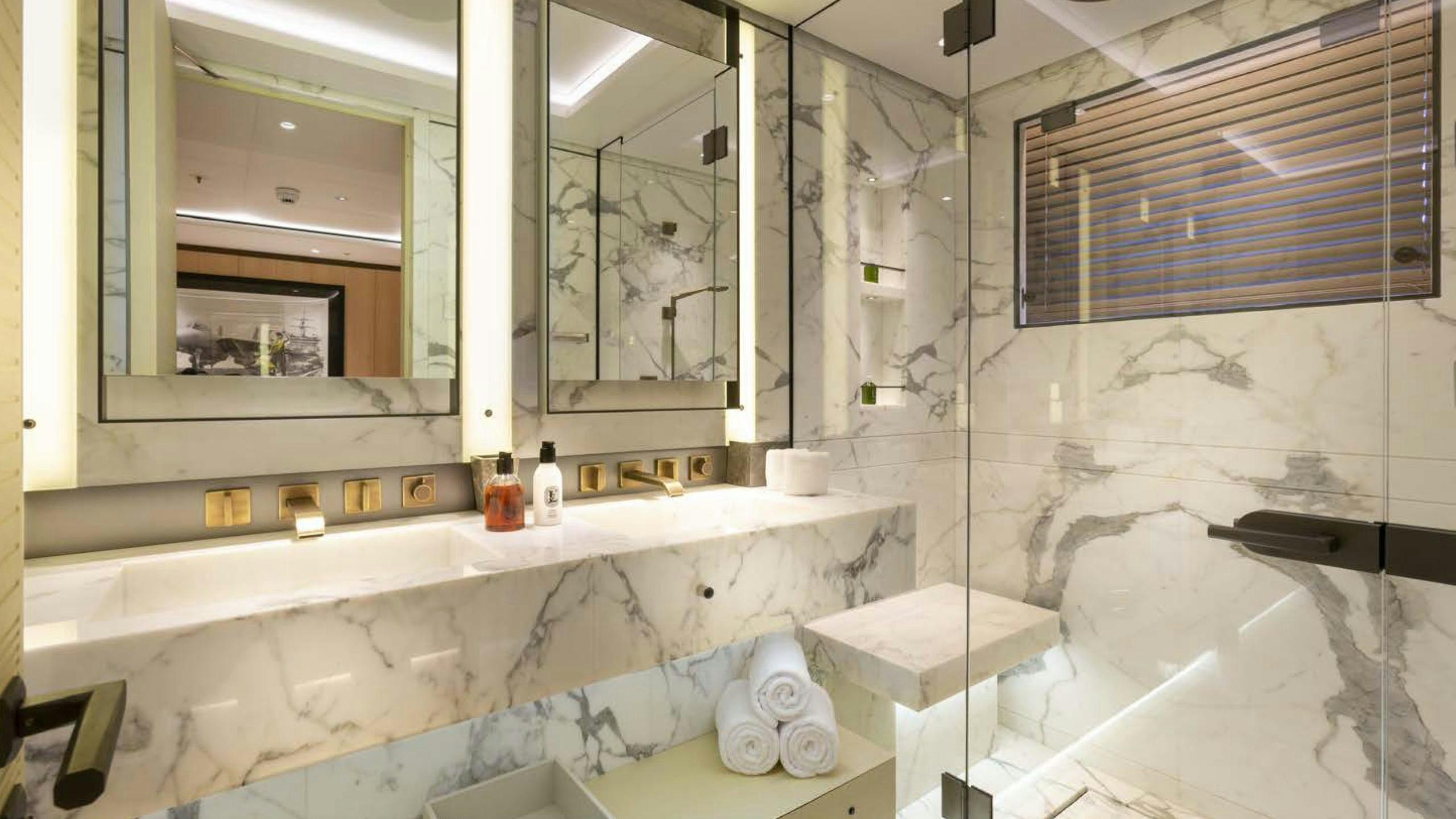 a bathroom with a tub and a sink aboard LUNASEA Yacht for Charter