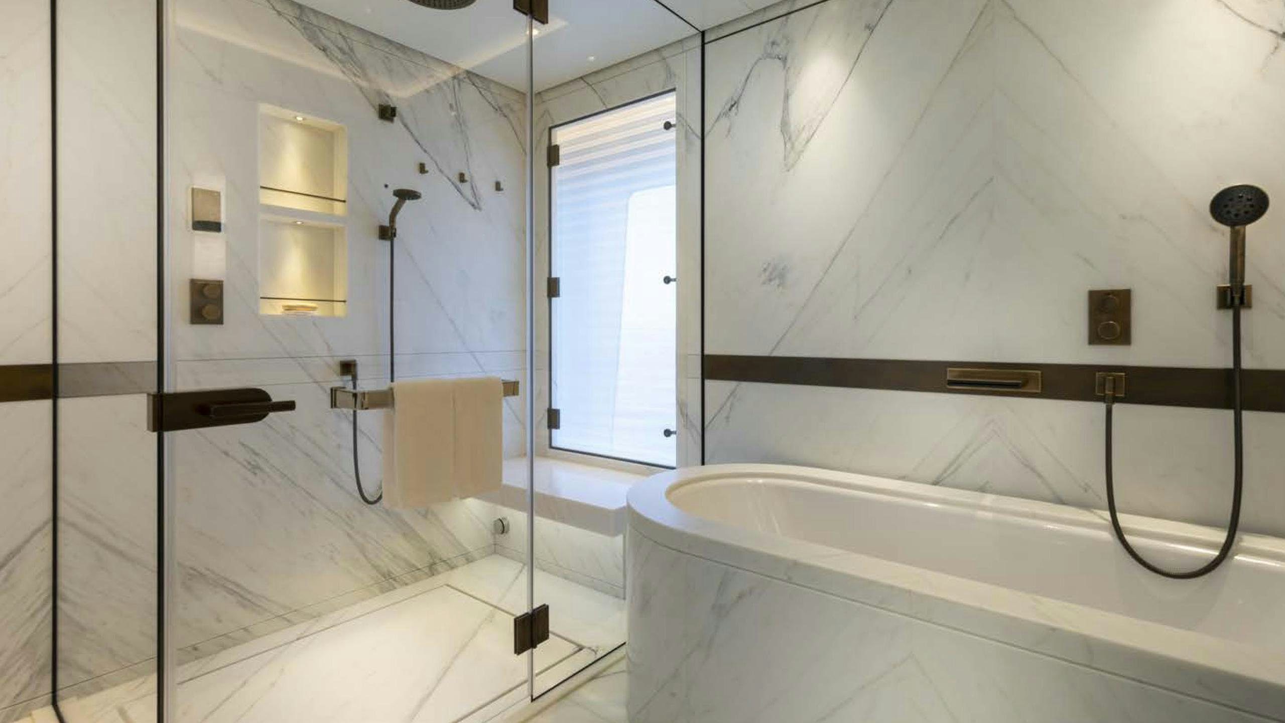 a bathroom with a tub and shower aboard LUNASEA Yacht for Charter
