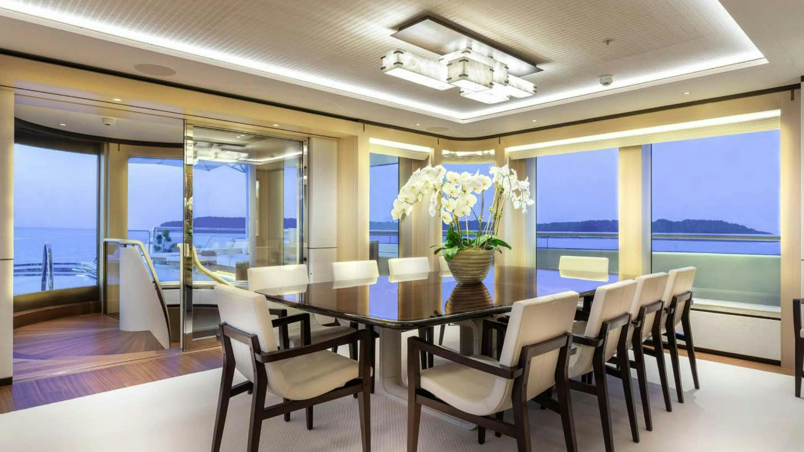 a dining room with a view of the ocean aboard LUNASEA Yacht for Charter