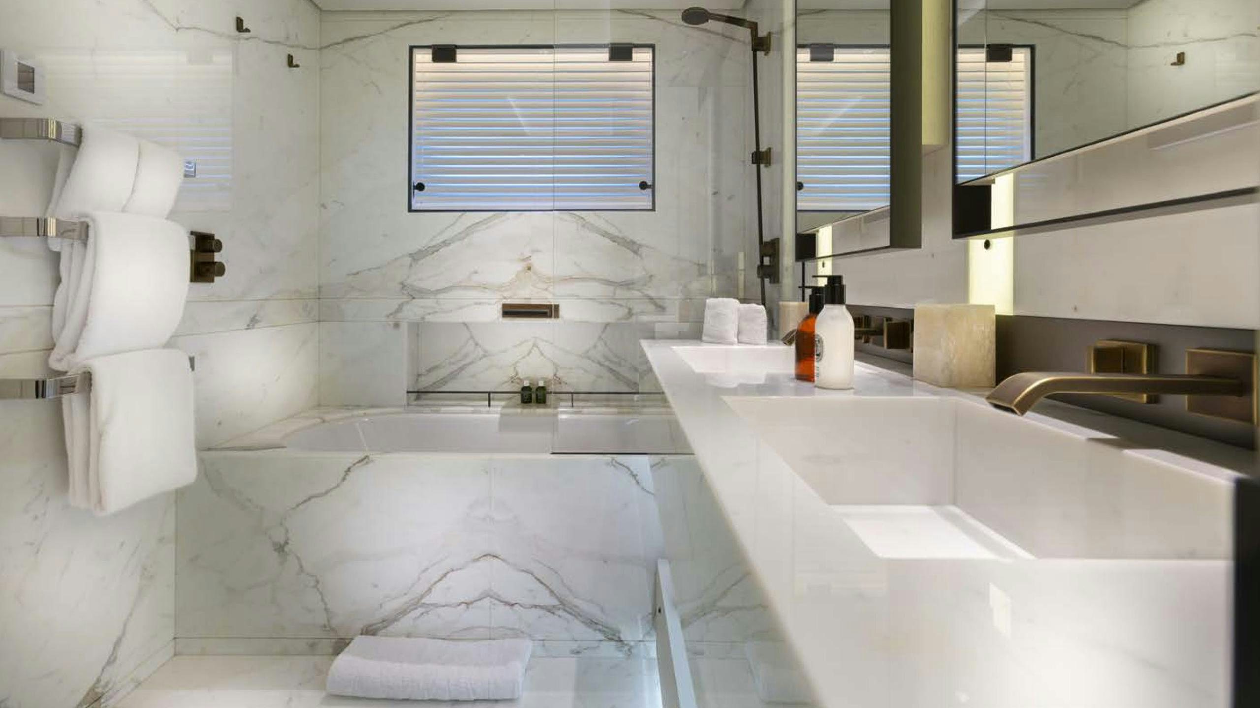 a bathroom with a tub and a sink aboard LUNASEA Yacht for Charter