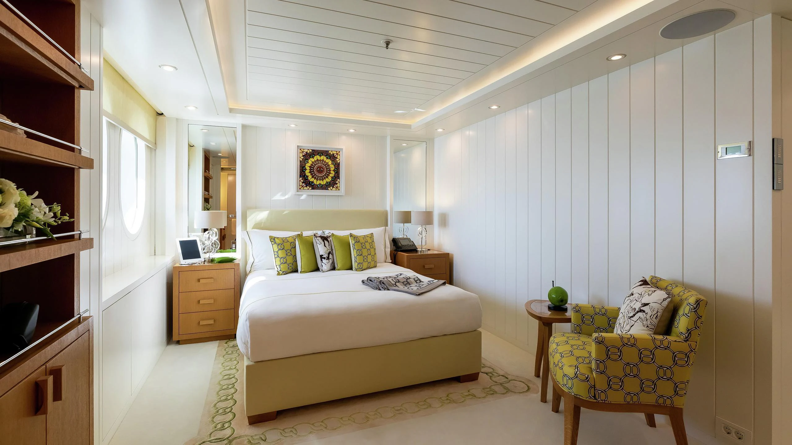 a bedroom with a bed and a chair aboard LADY E Yacht for Charter
