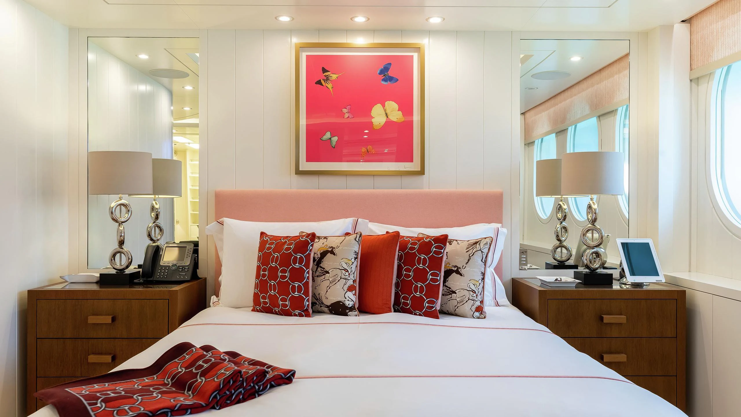 a bed with a white bed spread aboard LADY E Yacht for Charter