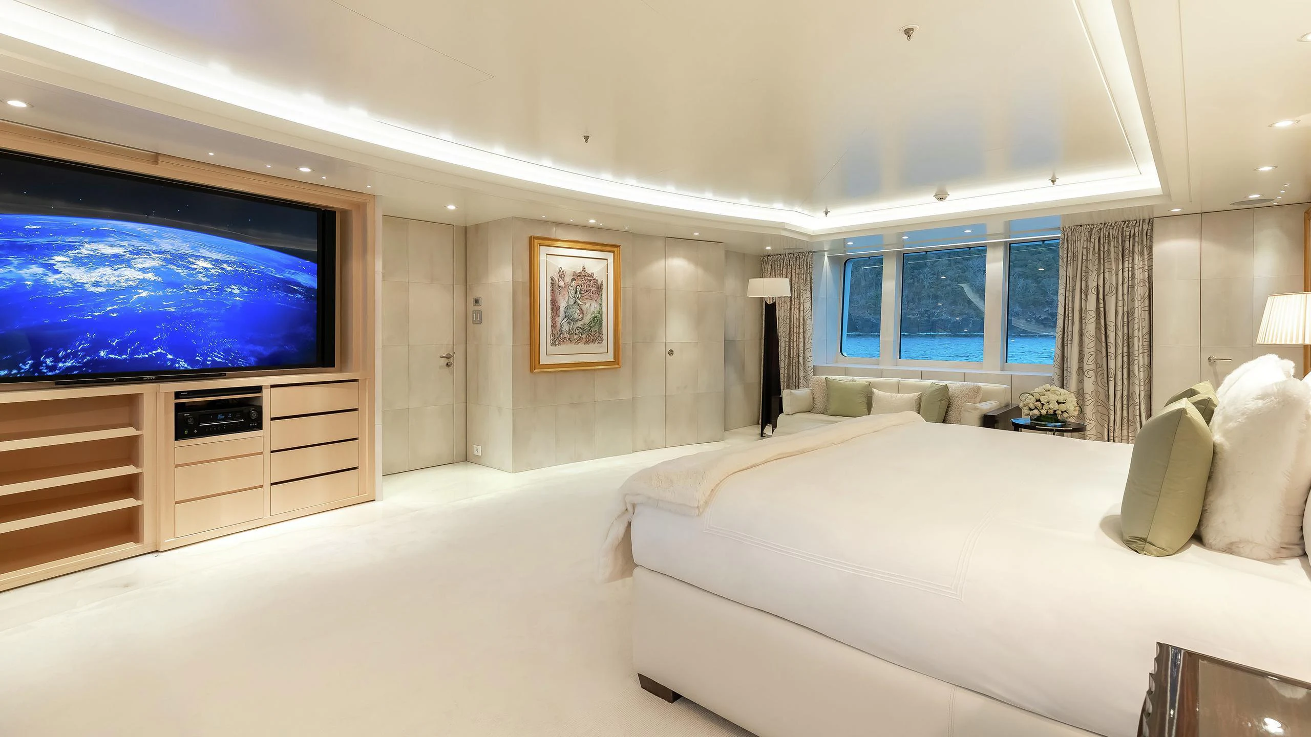 a large hotel room with a large screen television aboard LADY E Yacht for Charter