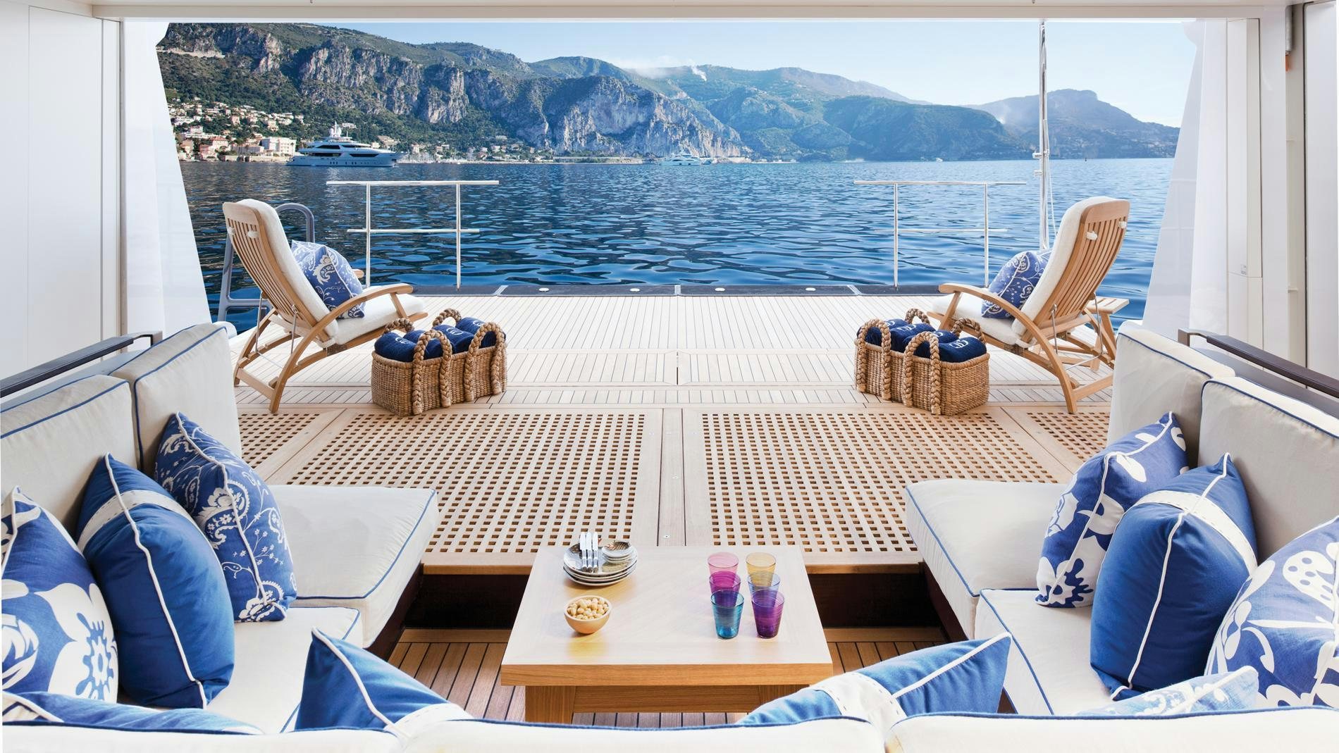 a room with a table chairs and a view of the mountains aboard BATON ROUGE Yacht for Charter