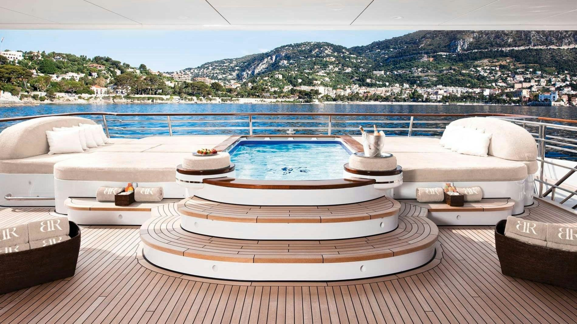 a deck with a large pool aboard BATON ROUGE Yacht for Charter