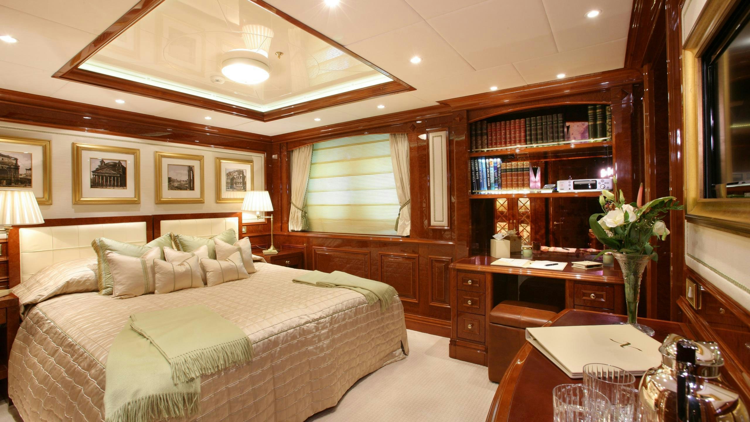 a room with a bed and a book shelf aboard ST DAVID Yacht for Charter