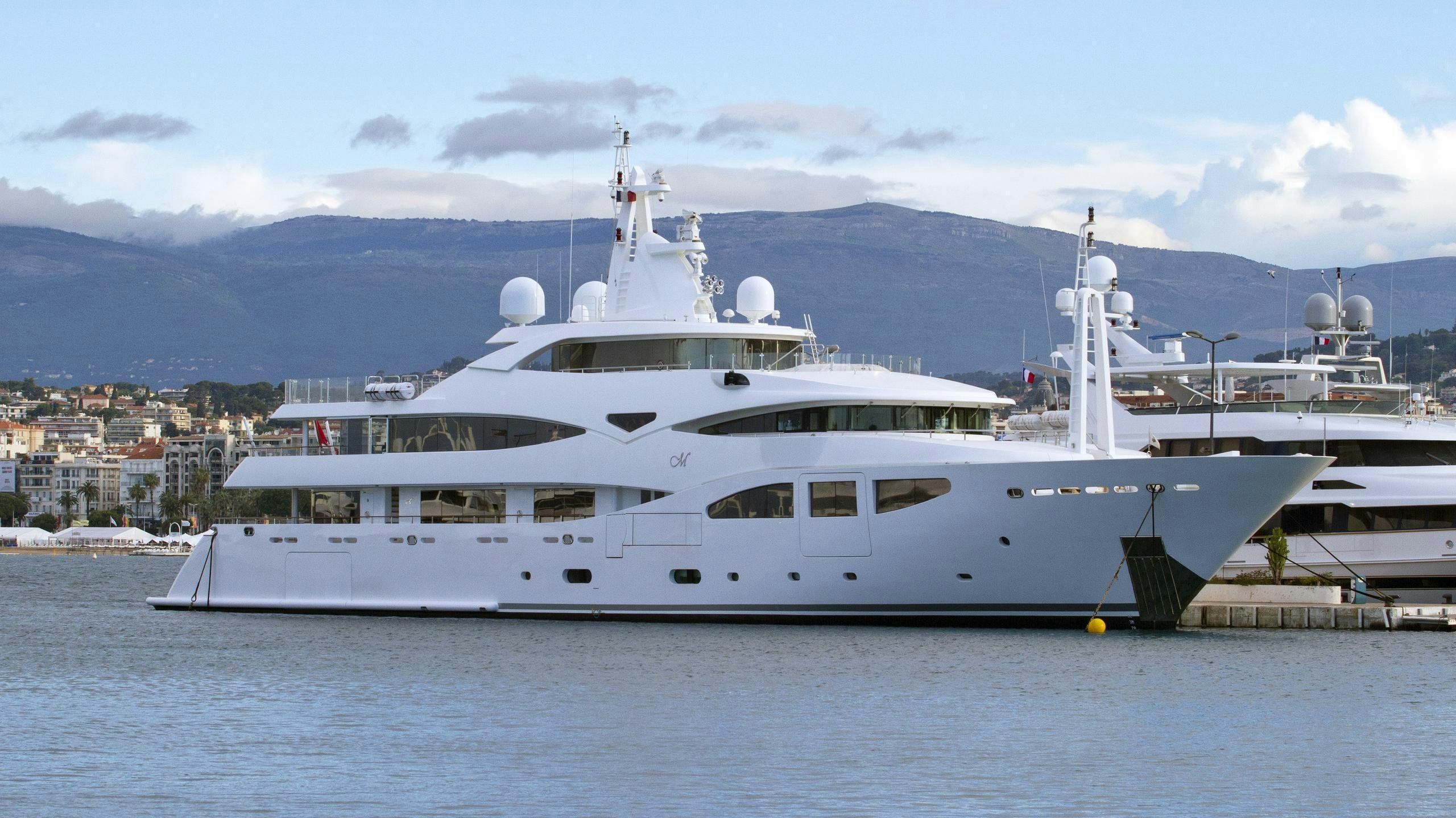 a couple of large white yachts aboard CLELIA III Yacht for Charter