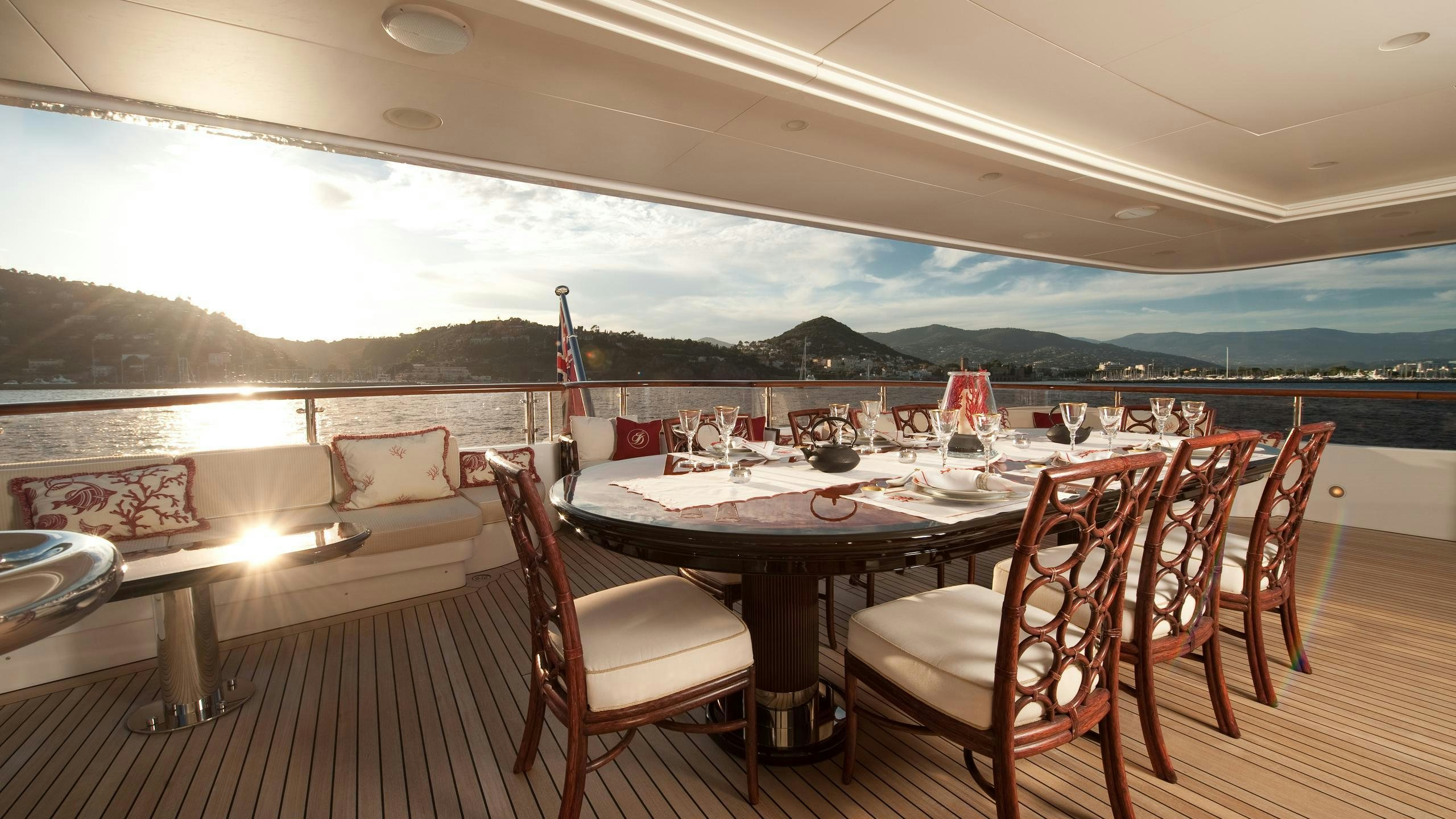 a table set for a dinner on a deck aboard IDYLLIC Yacht for Charter