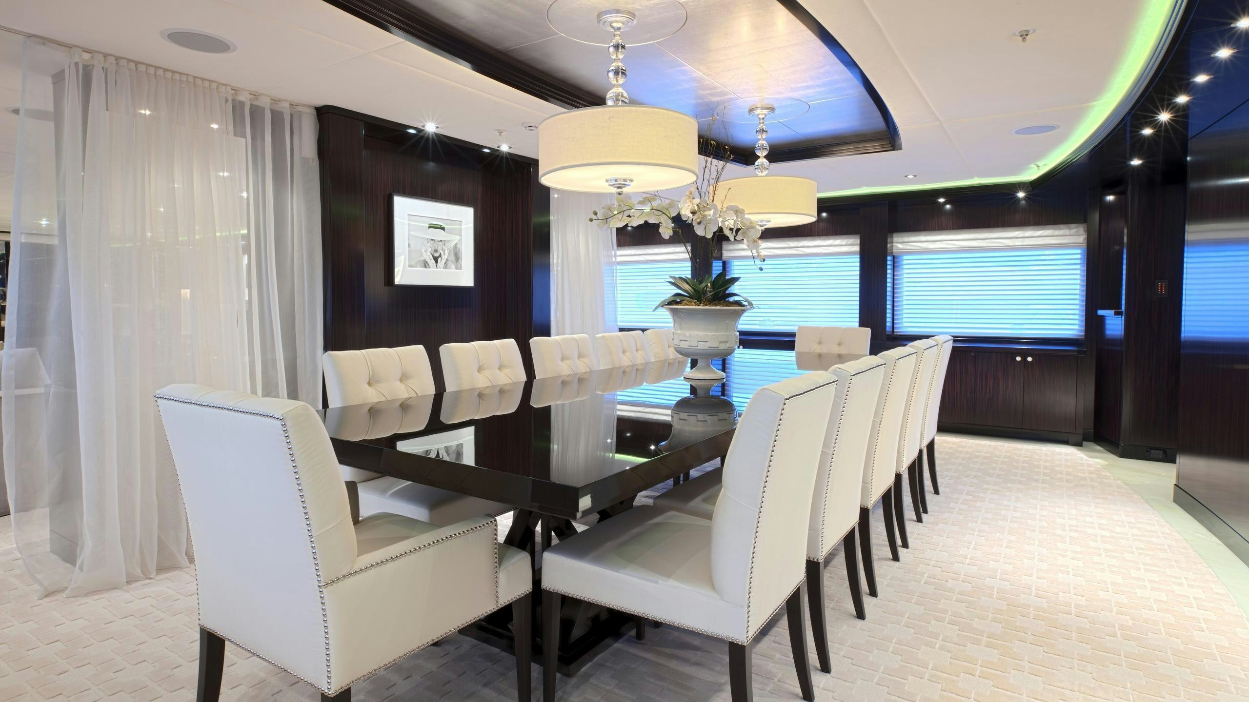 a room with chairs and a table aboard CARPE DIEM Yacht for Charter