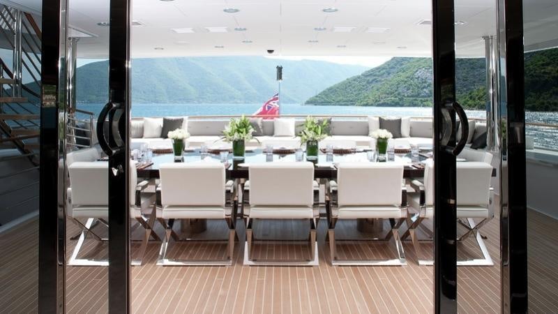 a room with a table and chairs aboard CARPE DIEM Yacht for Charter