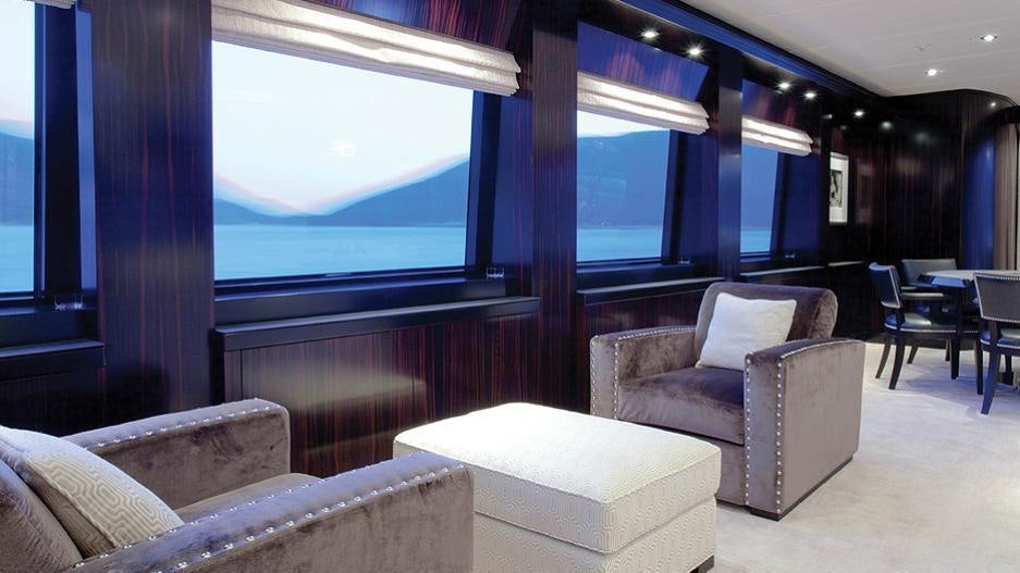 a room with a couch and a tv aboard CARPE DIEM Yacht for Charter