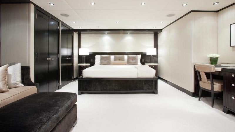 a large bedroom with a bed and a desk aboard CARPE DIEM Yacht for Charter