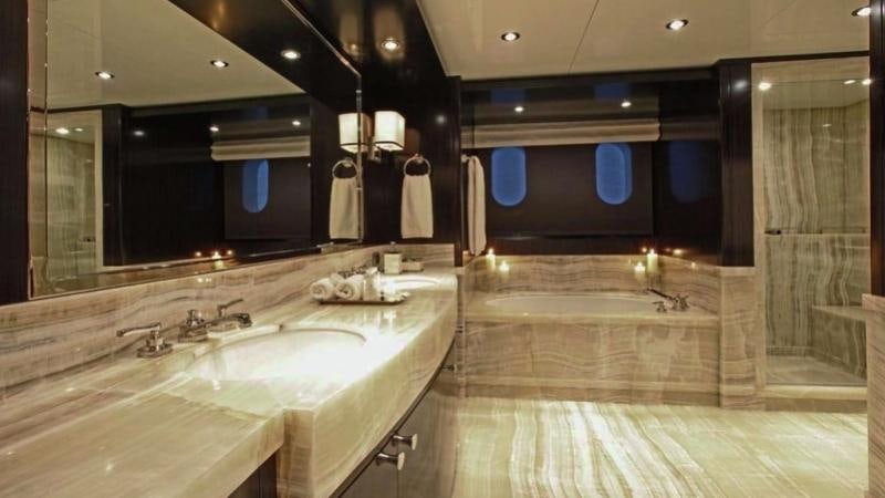 a bathroom with a large marble countertop aboard CARPE DIEM Yacht for Charter