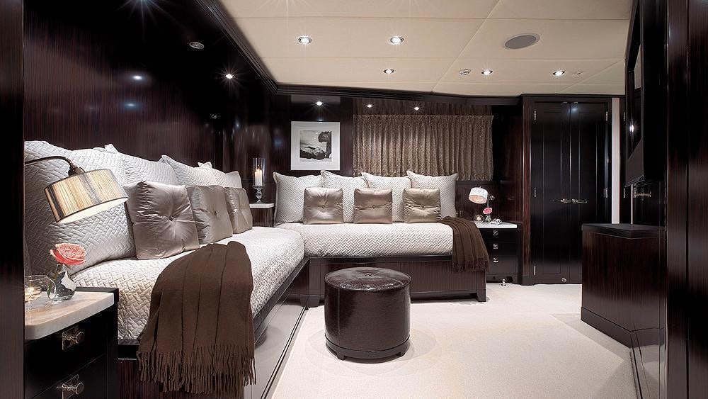 a room with a bed and a table aboard CARPE DIEM Yacht for Charter