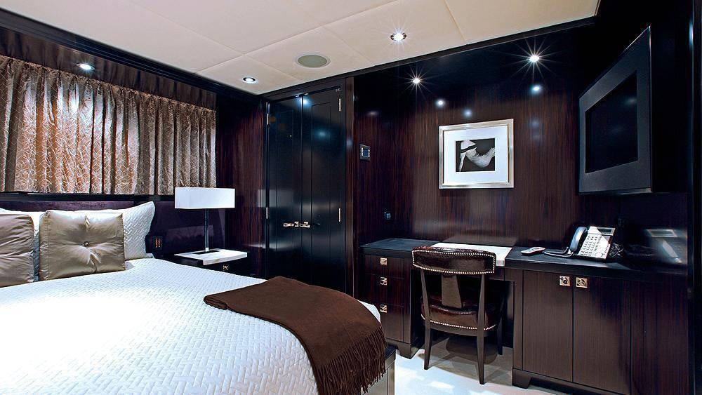a hotel room with a bed and desk aboard CARPE DIEM Yacht for Charter