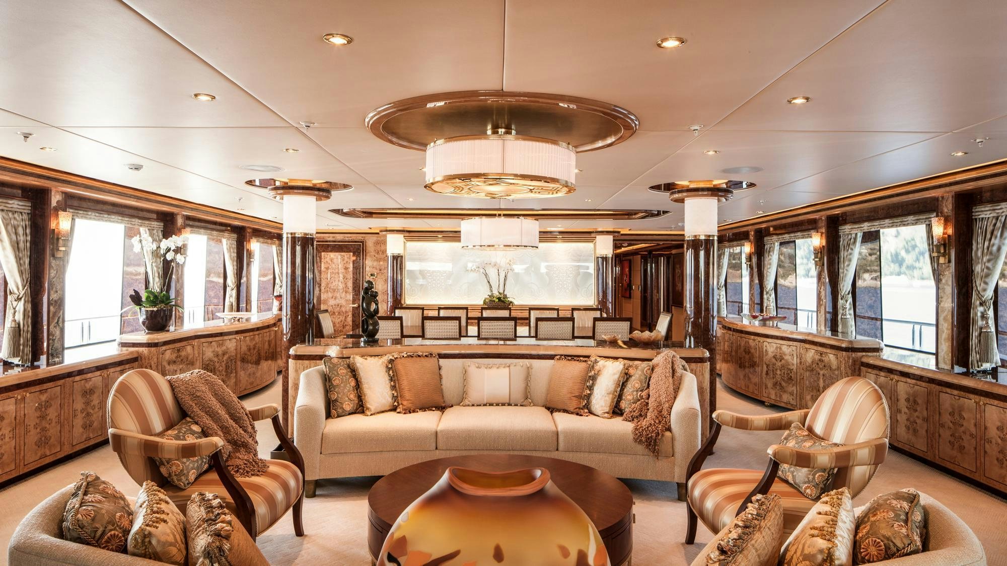 a living room with a large chandelier aboard LIBERTY Yacht for Charter