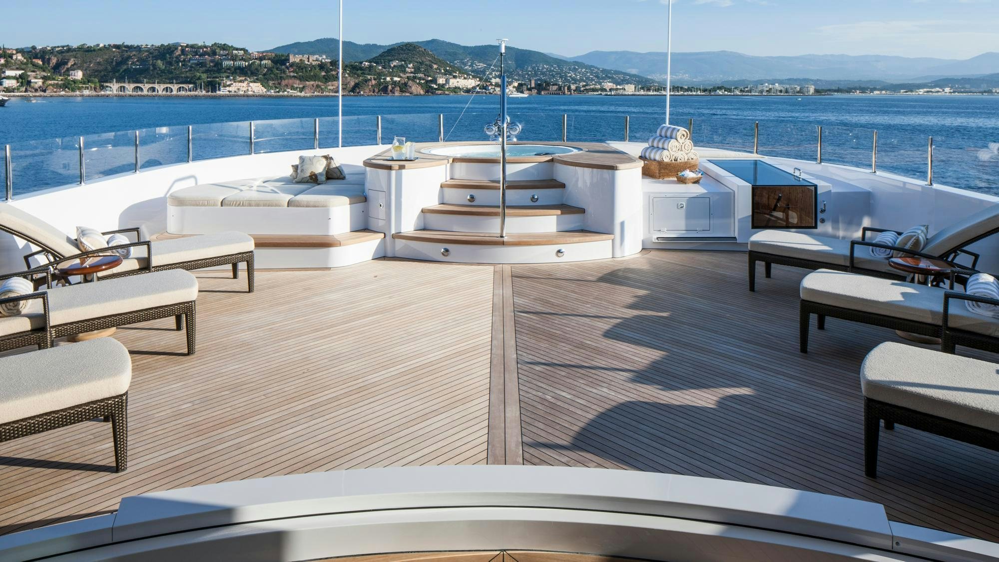 a room with a view of the water and a city aboard LIBERTY Yacht for Charter