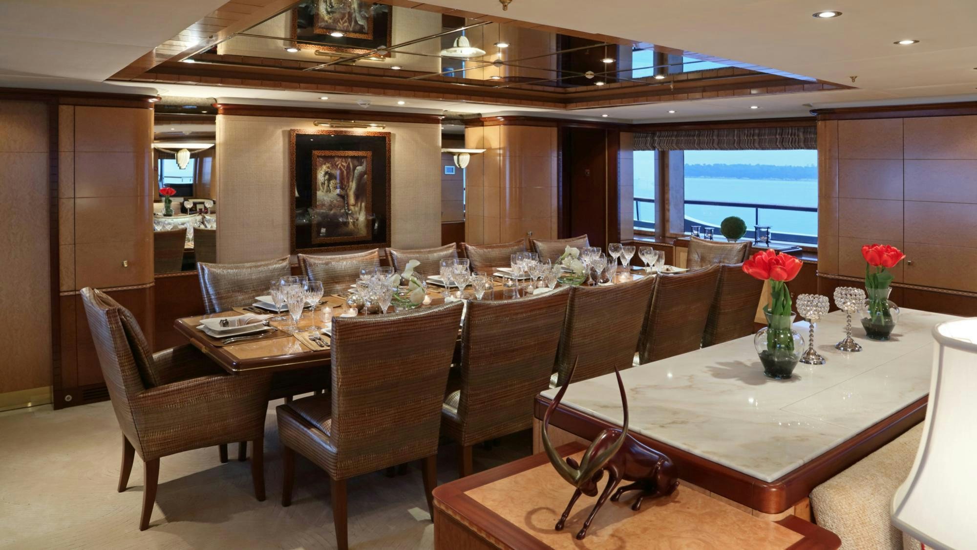 a large room with a table and chairs aboard JAGUAR Yacht for Charter