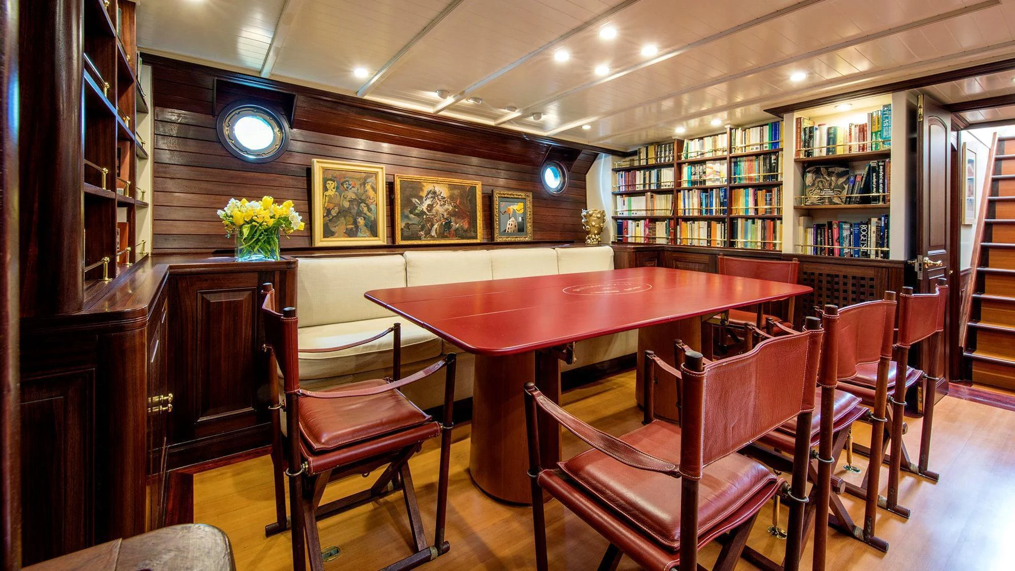 a room with a table chairs and a bench aboard SHENANDOAH OF SARK Yacht for Charter