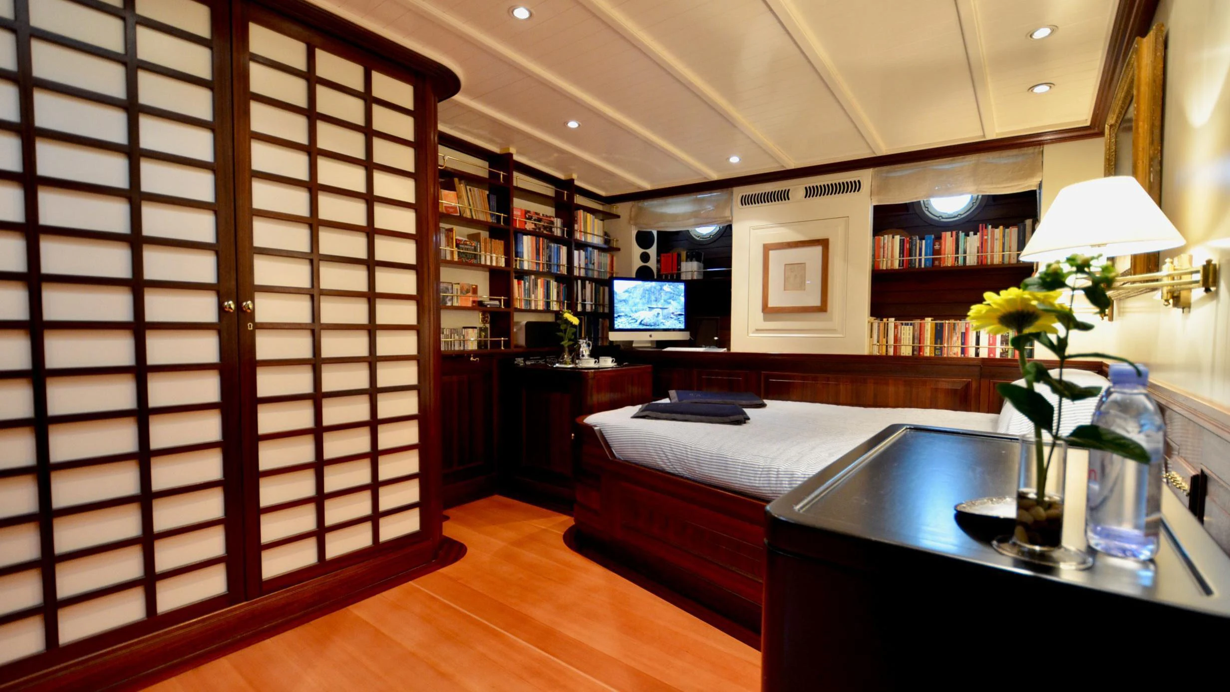 a room with a bed and a desk aboard SHENANDOAH OF SARK Yacht for Charter