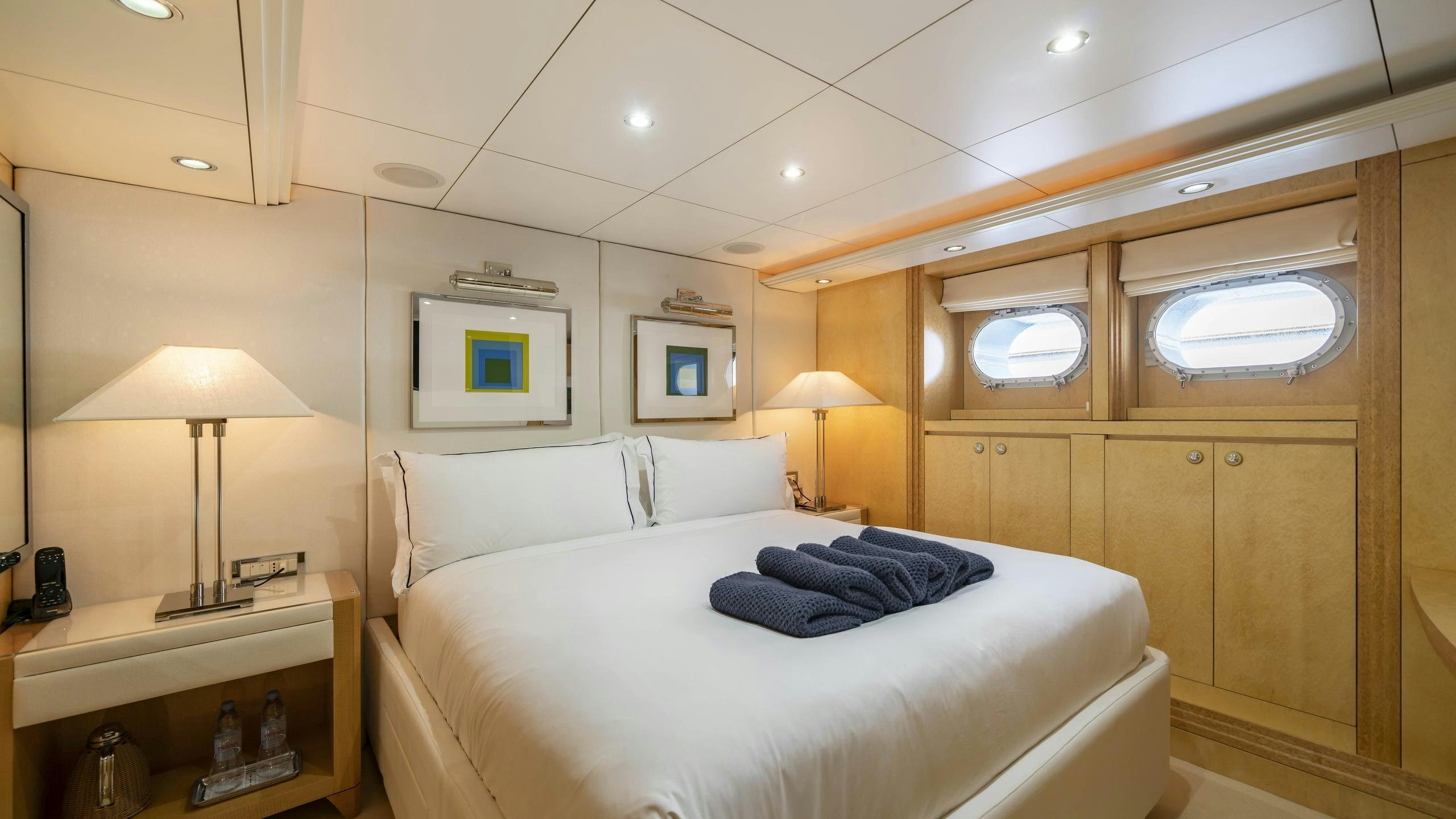 a room with a bed and a lamp aboard OCEANA I Yacht for Charter