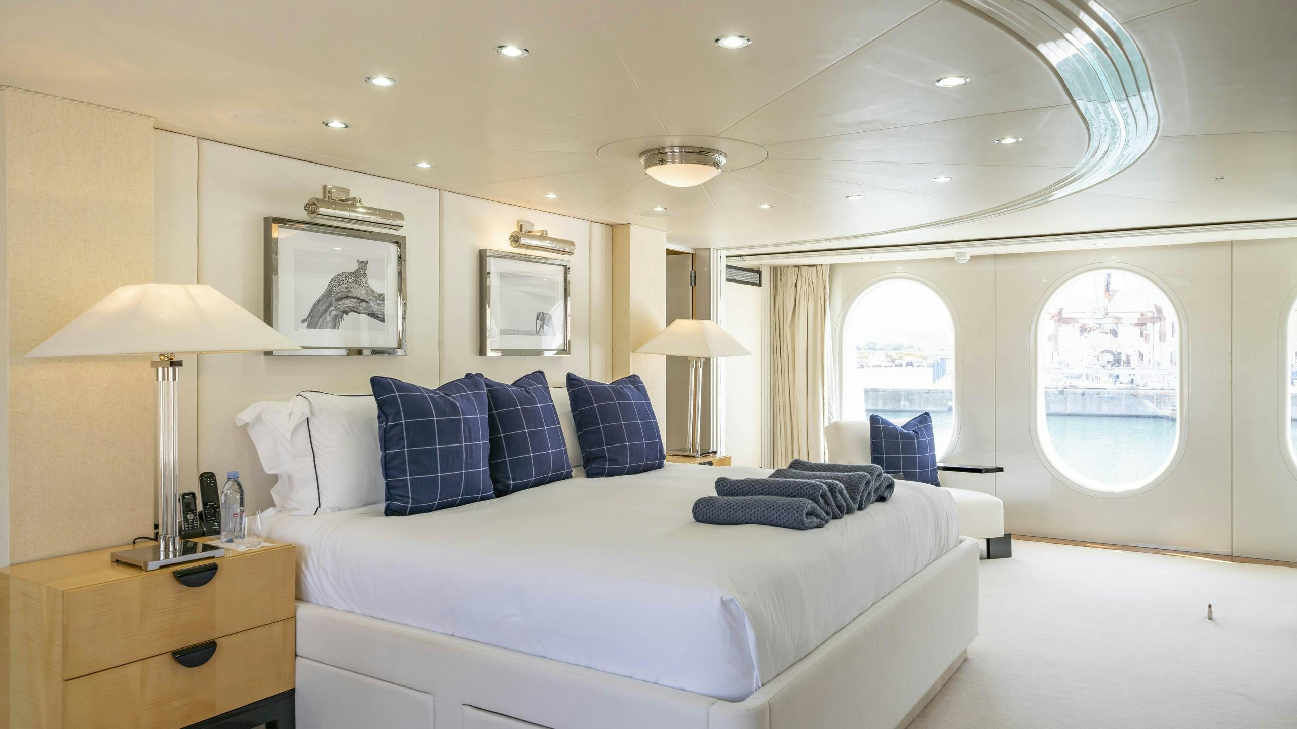 a large white bed in a room aboard OCEANA I Yacht for Charter