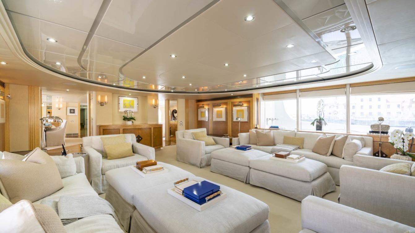 a living room with white couches and a large window aboard OCEANA I Yacht for Charter