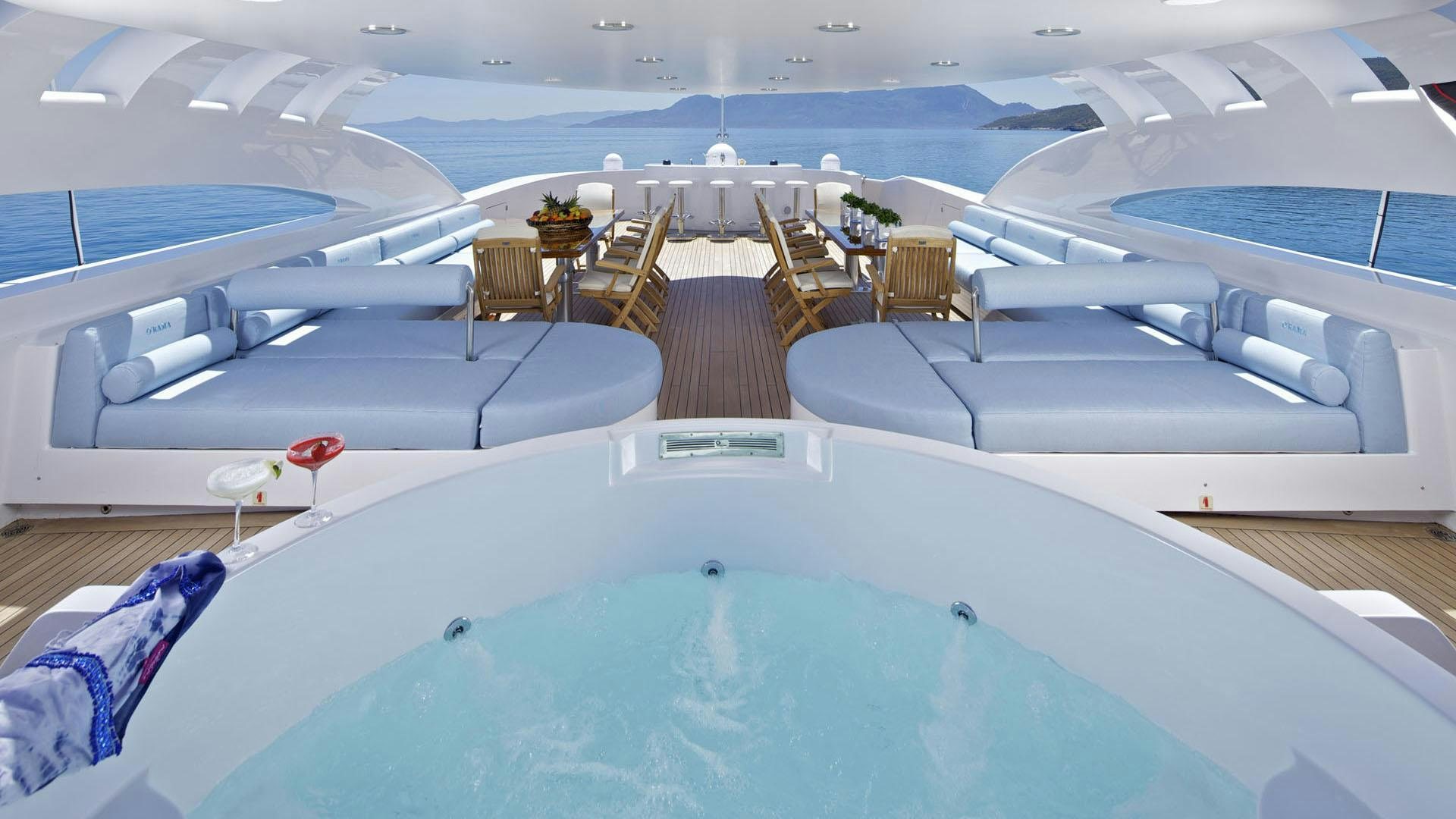 a room with a pool table and chairs aboard MIA RAMA Yacht for Charter