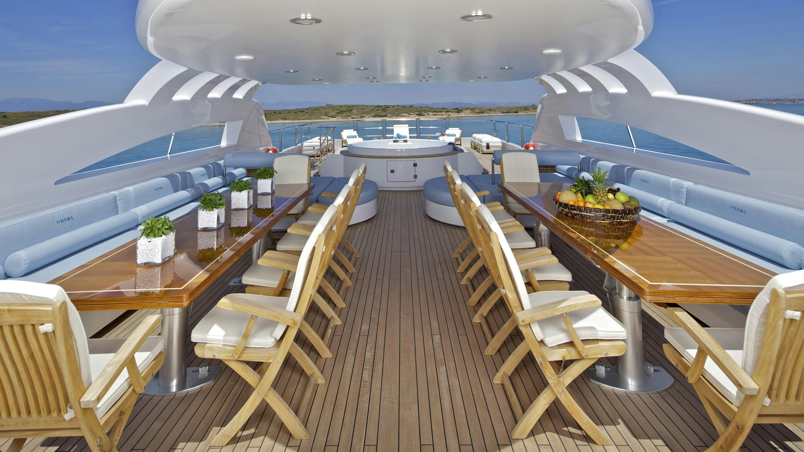 a deck with chairs and tables on it aboard MIA RAMA Yacht for Charter