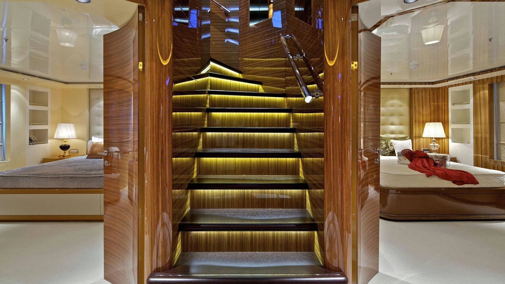 a room with a bed and a staircase aboard MIA RAMA Yacht for Charter