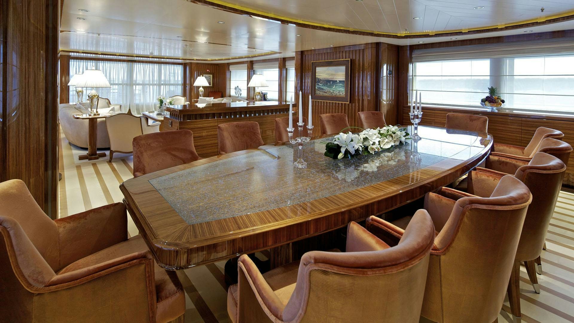a large room with a table and chairs aboard MIA RAMA Yacht for Charter