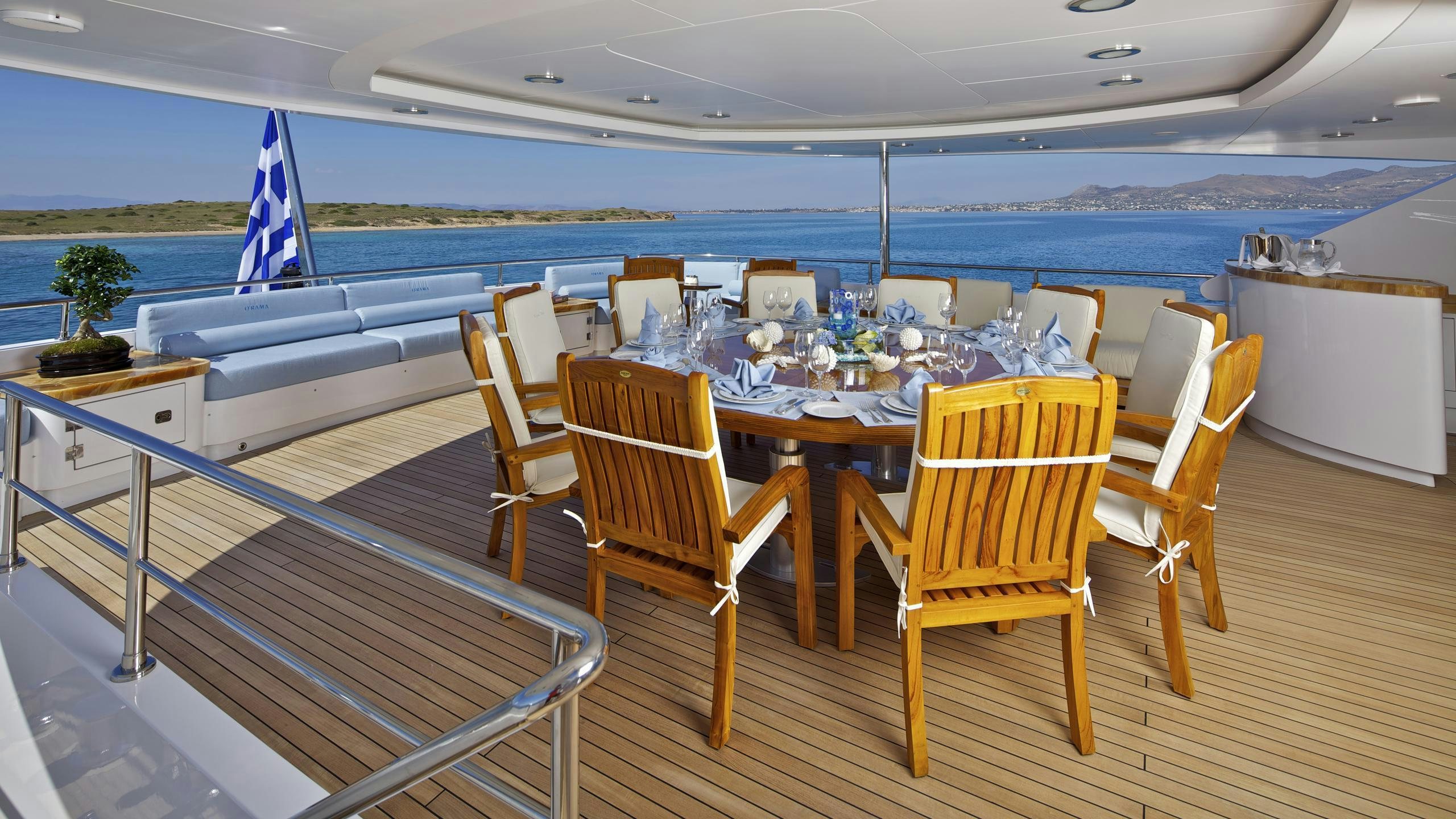 a table set for a dinner party aboard MIA RAMA Yacht for Charter