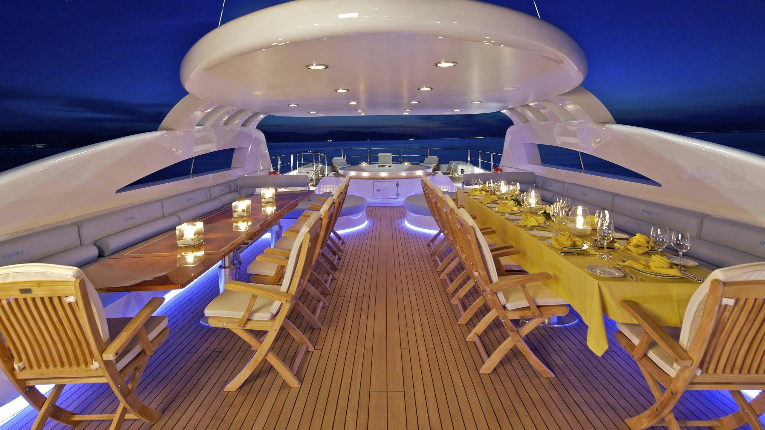 a deck with chairs and tables on it aboard MIA RAMA Yacht for Charter