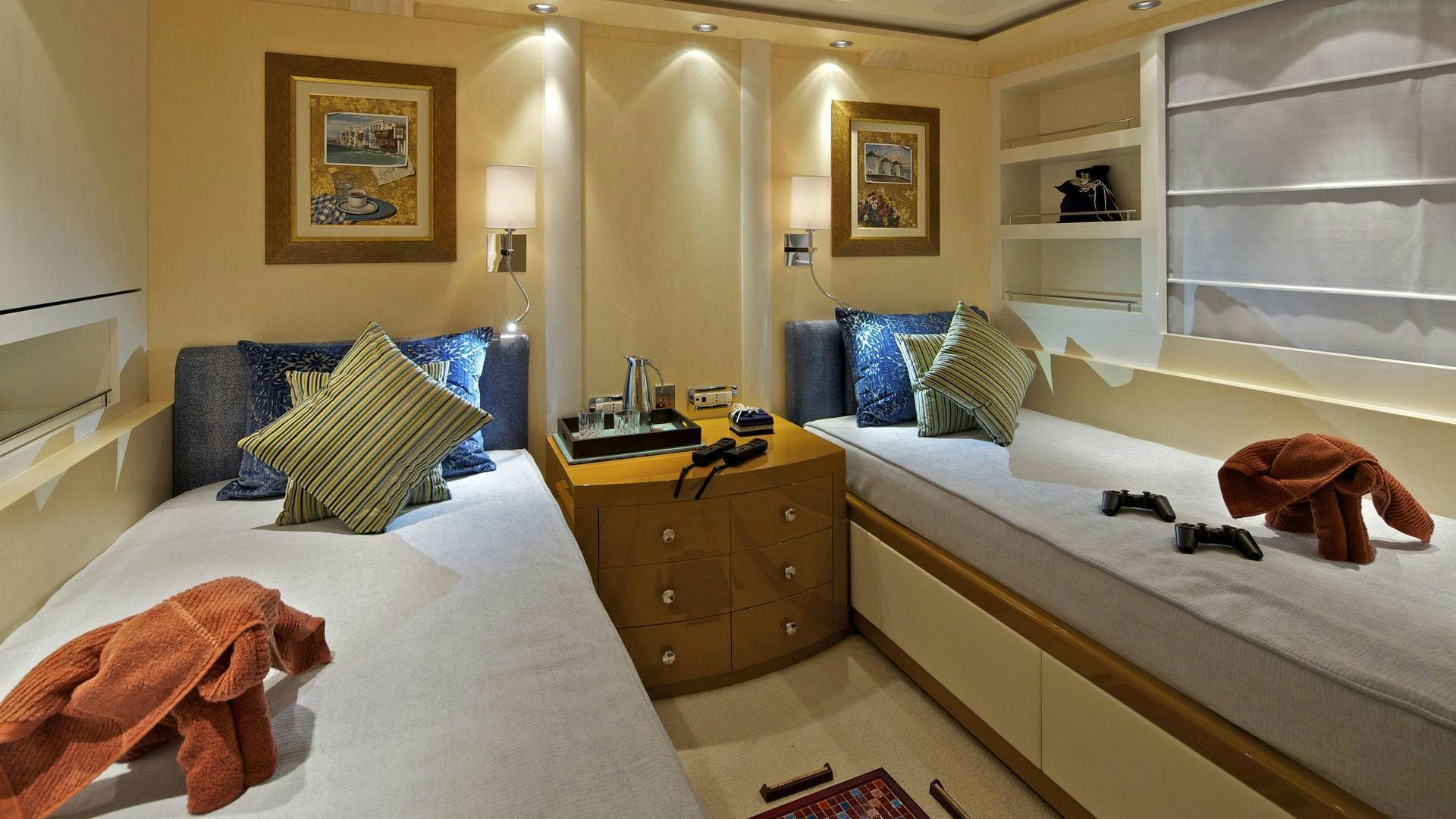 a room with a bed and a dresser aboard MIA RAMA Yacht for Charter