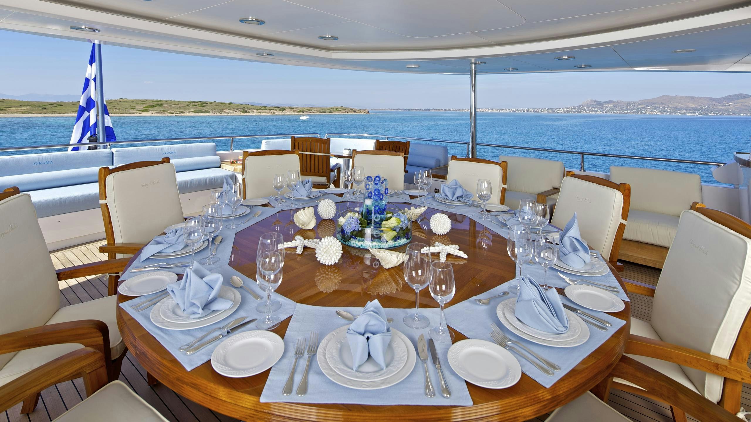 a table set for a dinner aboard MIA RAMA Yacht for Charter