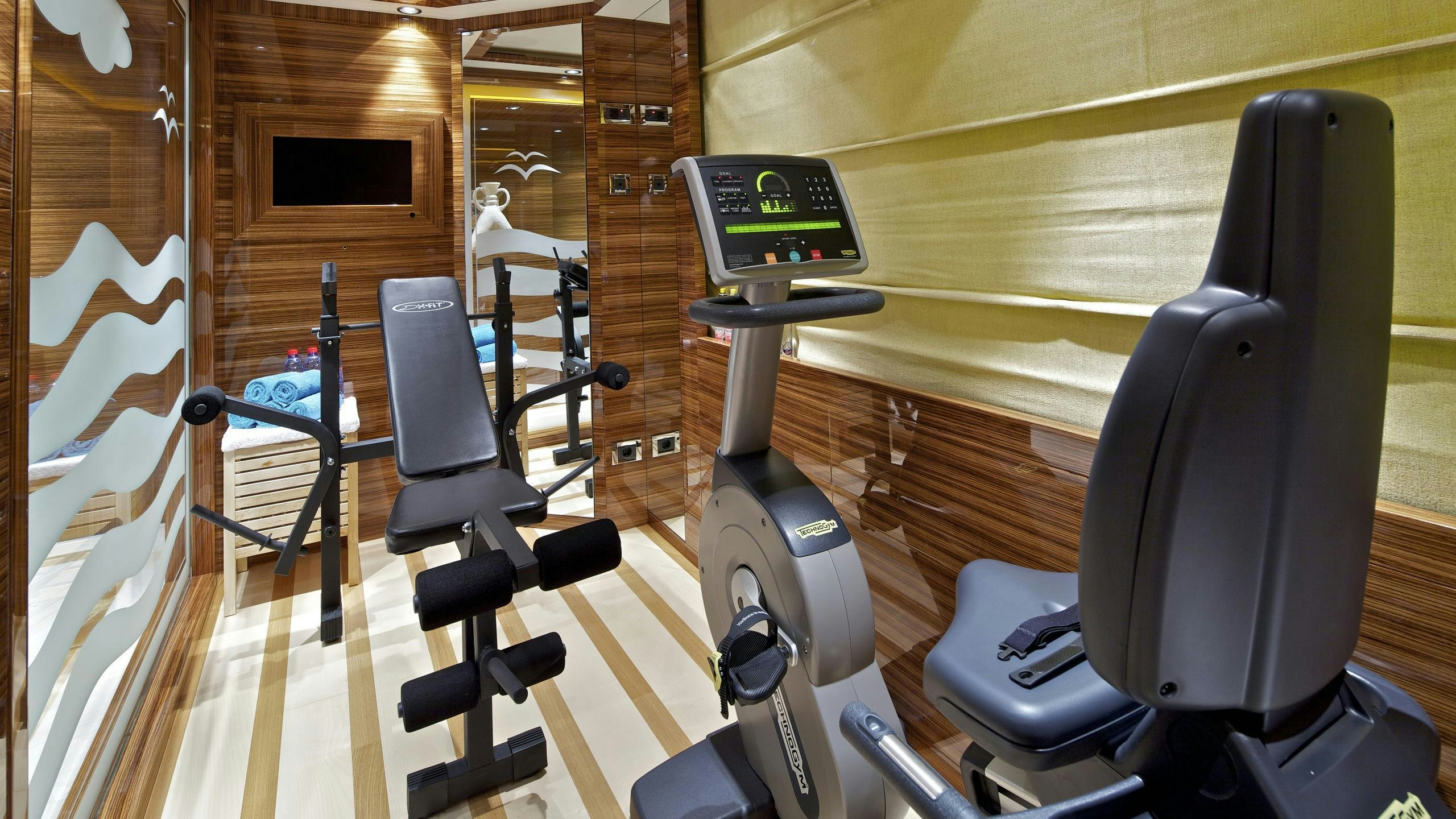 a gym with exercise equipment aboard MIA RAMA Yacht for Charter