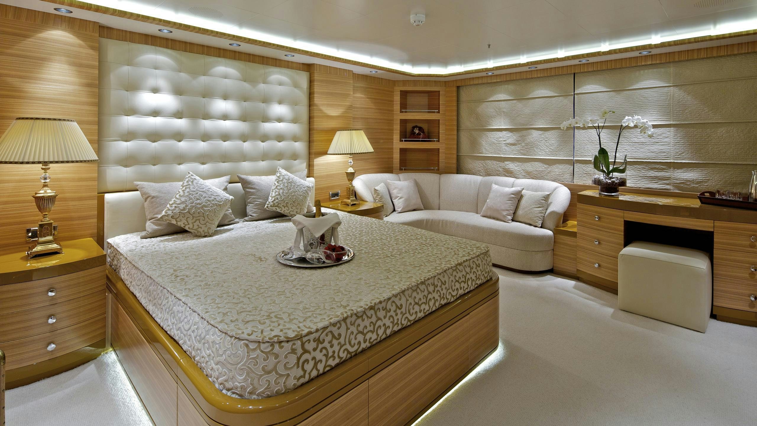 a large bedroom with a bed and a desk aboard MIA RAMA Yacht for Charter