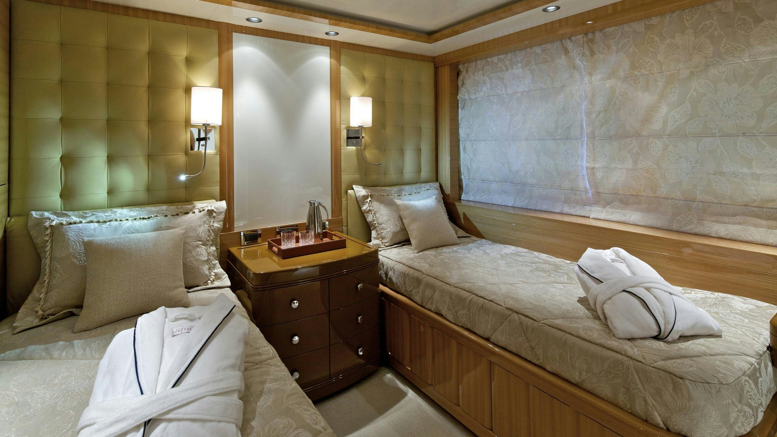 a room with a bed and a dresser aboard MIA RAMA Yacht for Charter