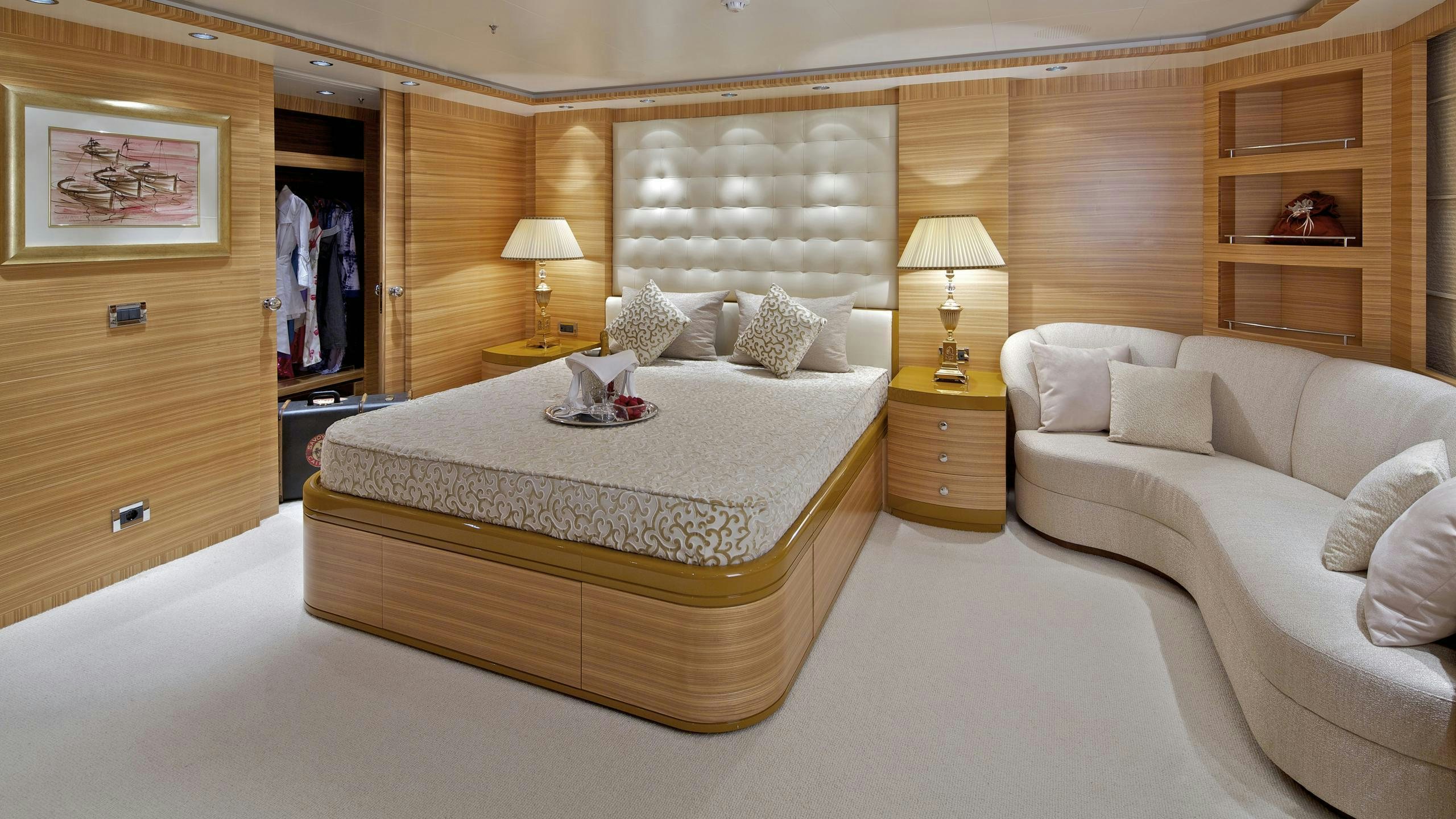 a bedroom with a bed and a lamp aboard MIA RAMA Yacht for Charter
