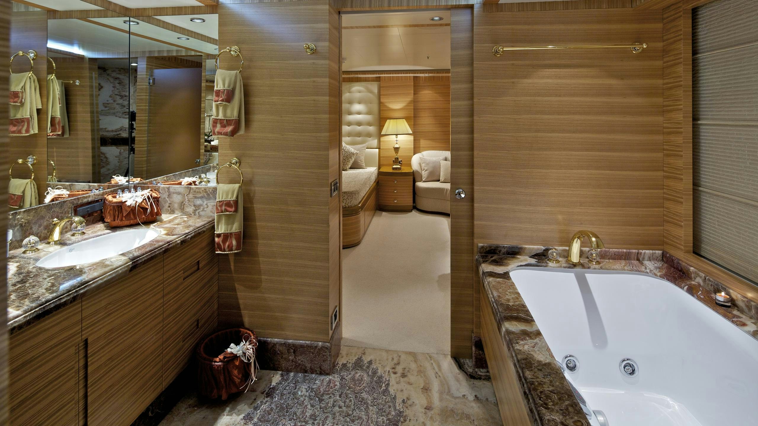 a bathroom with a tub sink and a mirror aboard MIA RAMA Yacht for Charter