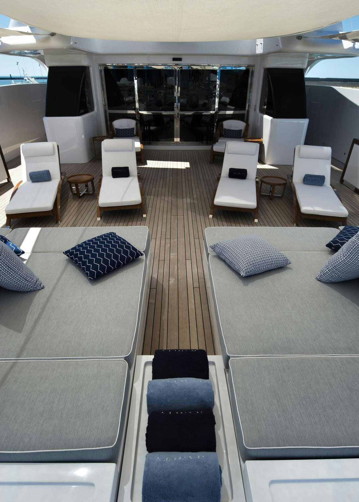 a room with a bed and a table aboard TALEYA Yacht for Charter