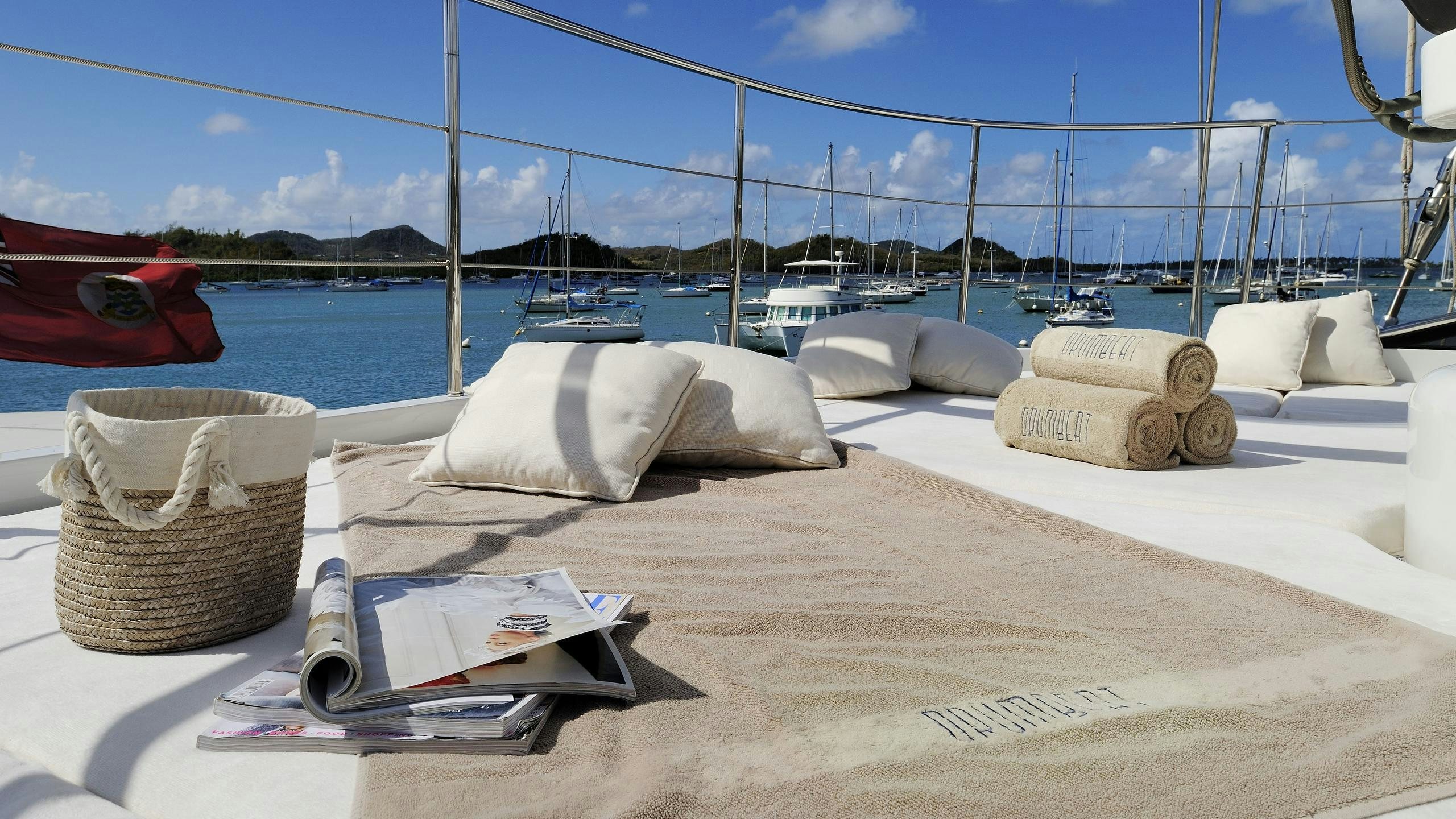 a white lounge chair on a beach aboard DRUMBEAT Yacht for Charter