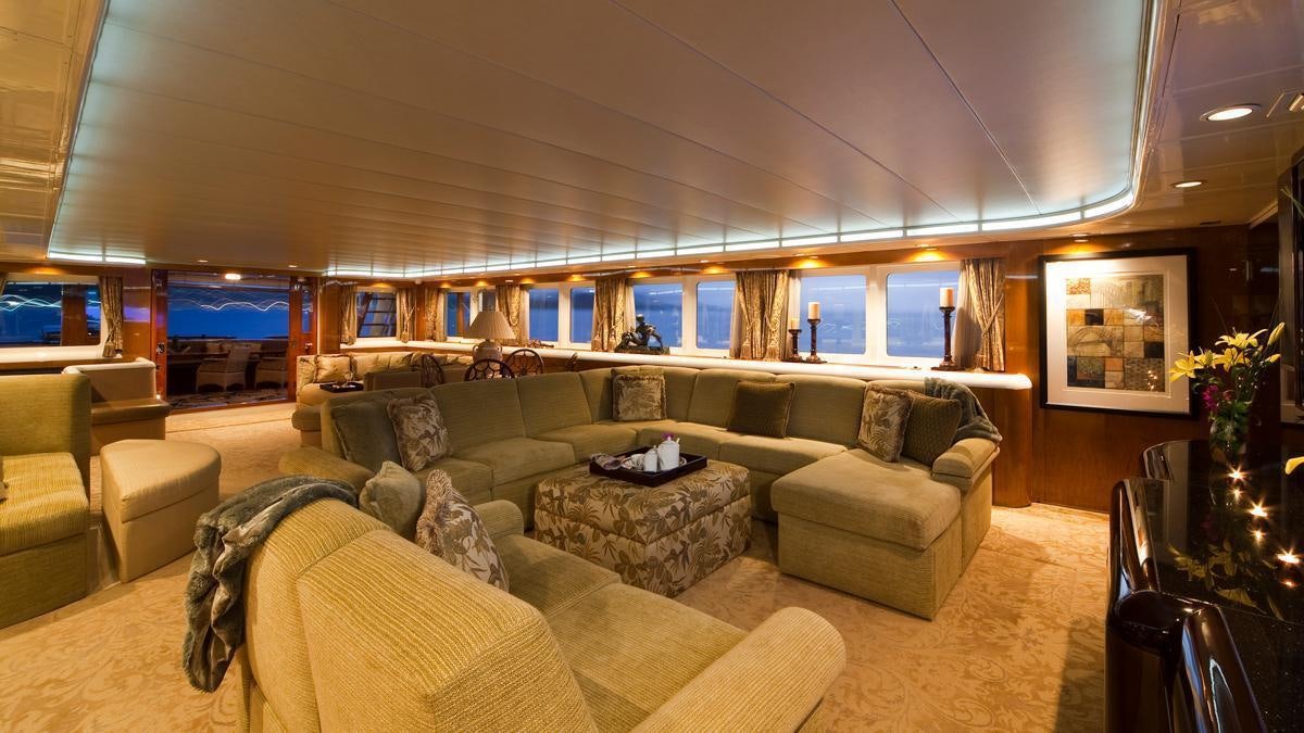 a living room with a couch and a table aboard BIG EAGLE Yacht for Charter
