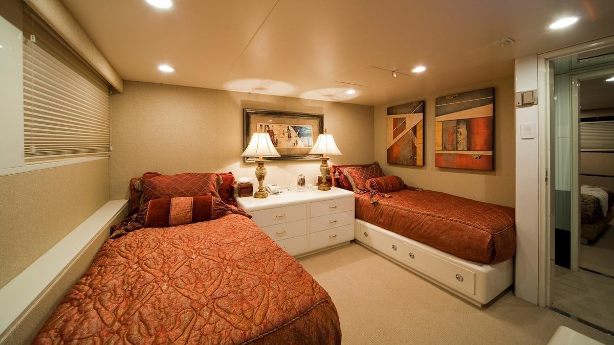 a bedroom with a bed and a couch aboard BIG EAGLE Yacht for Charter
