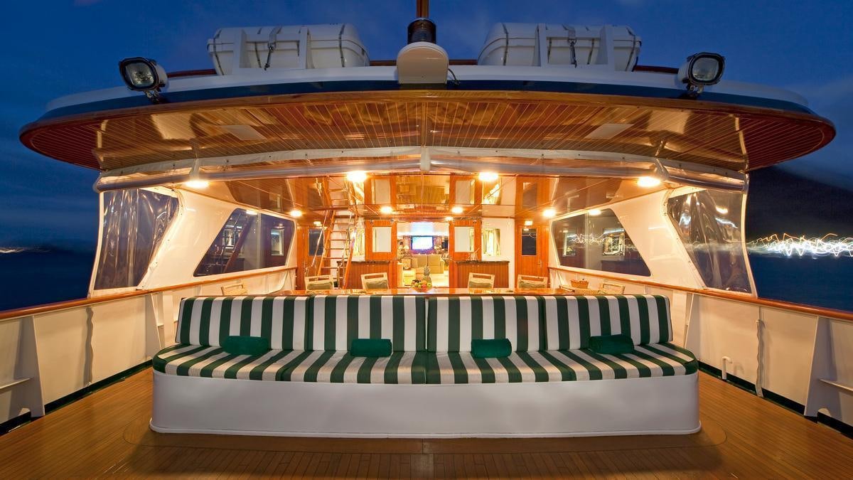 a room with a bed and a table aboard BIG EAGLE Yacht for Charter