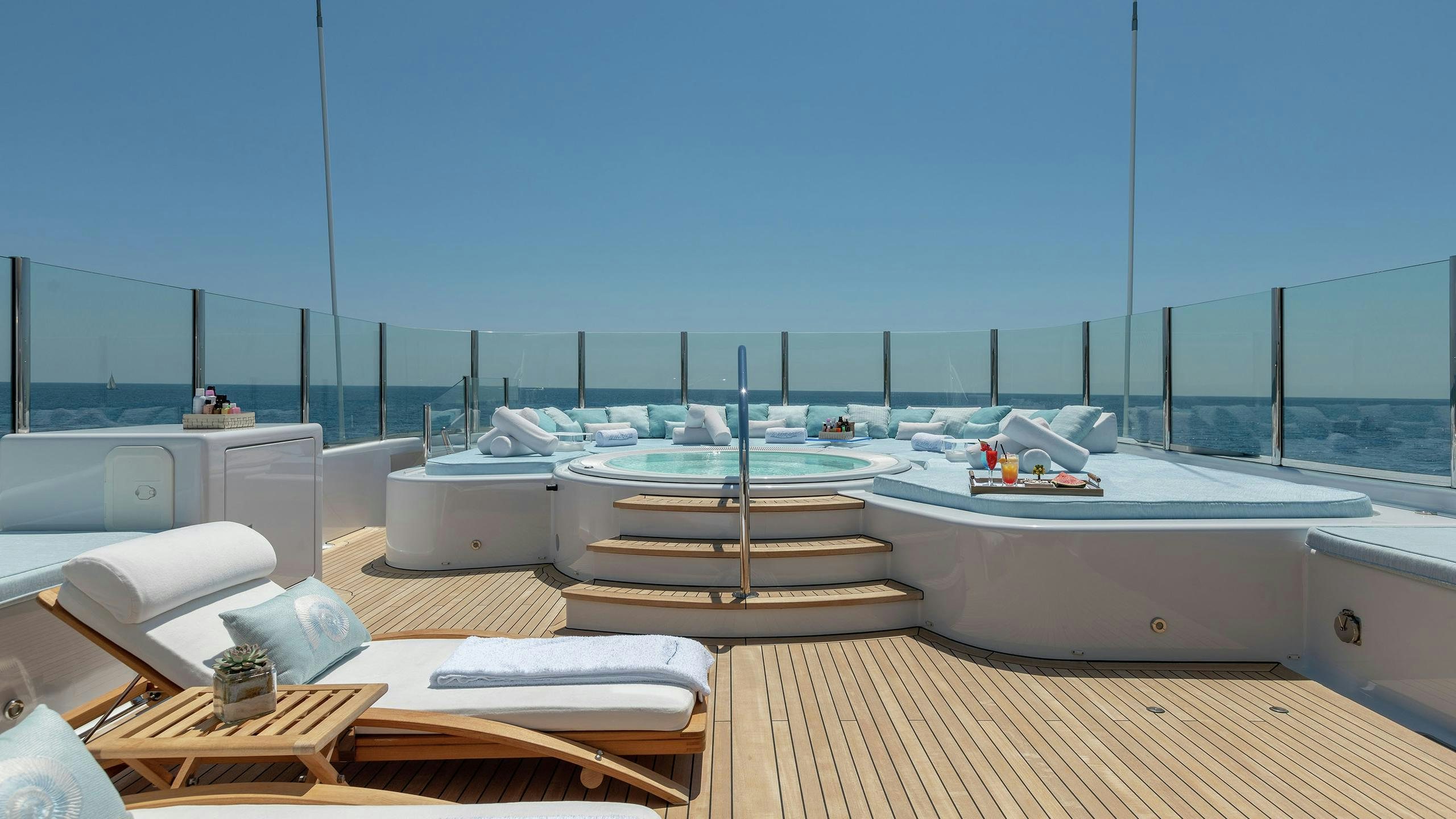 a room with a large deck overlooking the ocean aboard LA MIRAGE Yacht for Charter