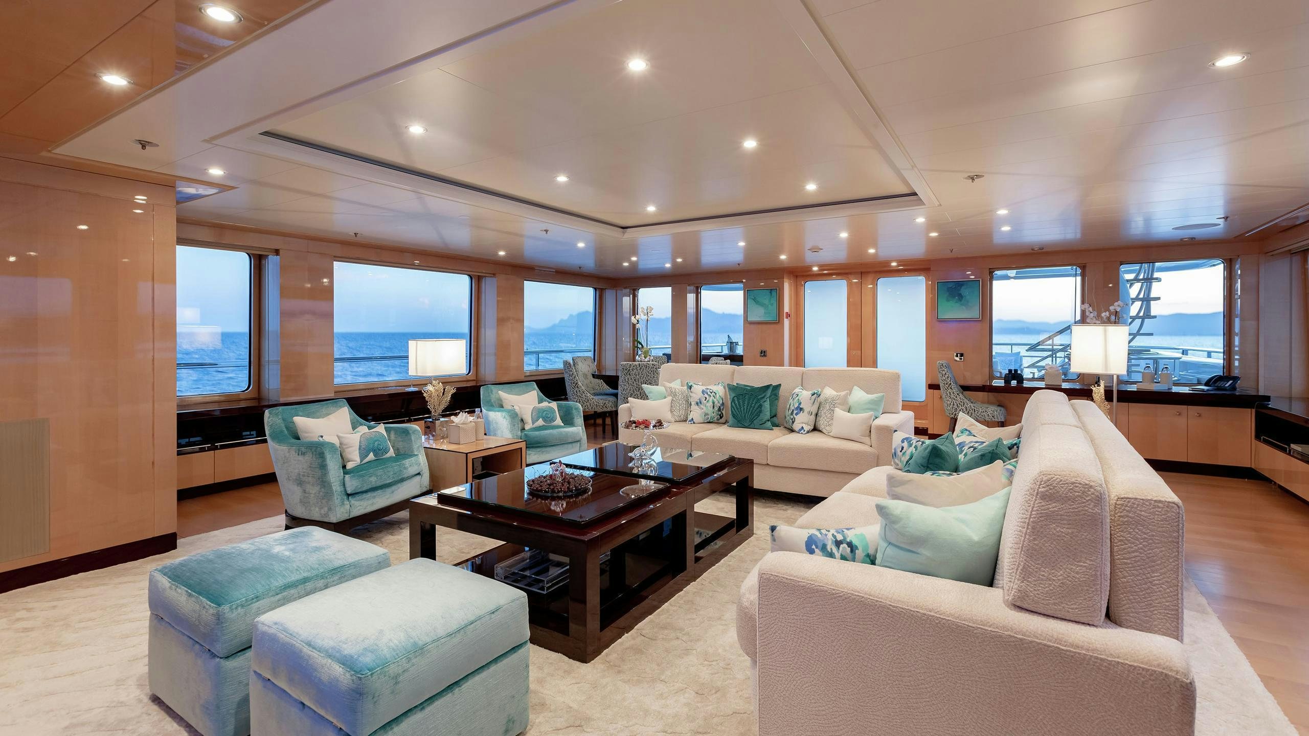 a living room with a large window aboard LA MIRAGE Yacht for Charter
