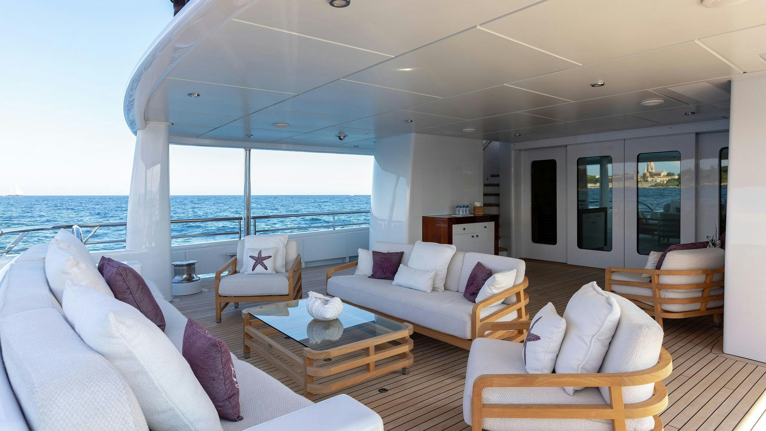 a living room with a large window aboard LA MIRAGE Yacht for Charter